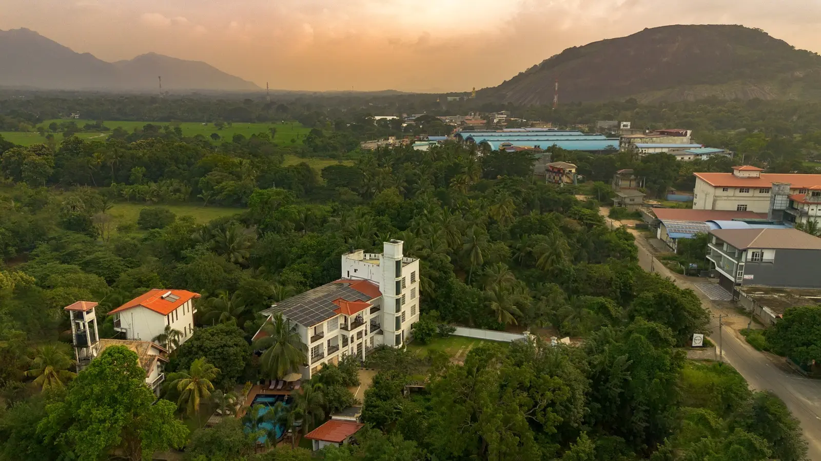 White Land City Hotel and the green Dambulla landscape at sunset