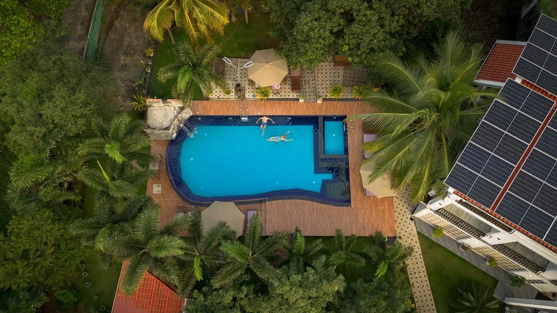 Aerial view of guests enjoying the main and baby pools at White Land City Hotel